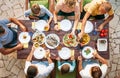 Big family have a dinner with fresh cooked meal on open garden t