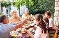 Big family have a dinner on garden terrace