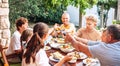 Big family have a dinner on garden terrace