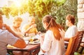 Big family have dinner on open garden terrace