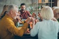 Big family of mature father mother small boy little girls pensioner celebrate fall october feasting holiday thanksgiving