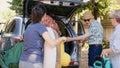 Big family packing voyage luggage in car trunk Royalty Free Stock Photo