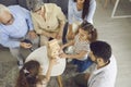 Big family plays the Jenga board game.