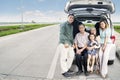 Big family sitting on the trunk of their car Royalty Free Stock Photo