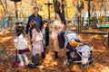 big family spends time together in autumn city park, children and parents playing, happy people walk and relax, ride scooters, Royalty Free Stock Photo