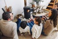 Big family wearing warm woolen socks resting by fireplace together Royalty Free Stock Photo