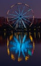 Big ferris wheel at night. Colorful reflection on the lake. Royalty Free Stock Photo