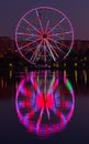 Big ferris wheel at night. Colorful reflection on the lake. Royalty Free Stock Photo