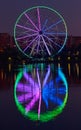 Big ferris wheel at night. Colorful reflection on the lake. Royalty Free Stock Photo