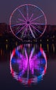 Big ferris wheel at night. Colorful reflection on the lake. Royalty Free Stock Photo