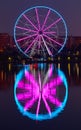 Big ferris wheel at night. Colorful reflection on the lake. Royalty Free Stock Photo