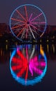 Big ferris wheel at night. Colorful reflection on the lake. Royalty Free Stock Photo