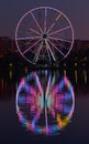 Big ferris wheel at night. Colorful reflection on the lake. Royalty Free Stock Photo