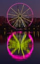 Big ferris wheel at night. Colorful reflection on the lake. Royalty Free Stock Photo