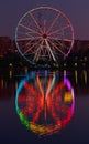 Big ferris wheel at night. Colorful reflection on the lake. Royalty Free Stock Photo