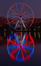 Big ferris wheel at night. Colorful reflection on the lake. Royalty Free Stock Photo