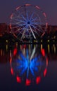 Big ferris wheel at night. Colorful reflection on the lake. Royalty Free Stock Photo