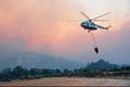 Big fire rescue helicopter gets water Royalty Free Stock Photo