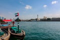 Big flag of United Arab Emirates flying high on city of Dubai in old town. Natoinal Day UAE. Royalty Free Stock Photo