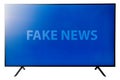 Big flat oled 4k display tv with blue background and the text fake news on the screen.