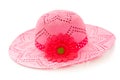Big and floppy pink hat with a deep pink flower and pink and white polka dot ribbon. Isolated on a white studio background Royalty Free Stock Photo