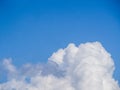 A big fluffy white cloud on a clear azure-blue sky Royalty Free Stock Photo