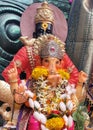 A big foot closeup of Lord Ganesha, Hindu God (with the head of an elephant). Behind god Vitthal. Royalty Free Stock Photo