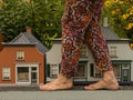Big foots and small houses.Unusual view.Gulliver in town. Royalty Free Stock Photo
