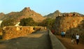 People on the big fort battlement and large wall at vellore fort with sunset