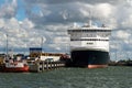 Big freighter or cruise ship loading at the harbor. Industrial container ship at terminal. Exporting products on a global scale