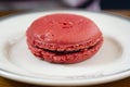 Big pink macaroon with raspberry, round cake cookie, in a plate. Royalty Free Stock Photo