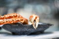 Closeup of big fresh tasty crab legs and claw chela in stylish grey bowl Royalty Free Stock Photo