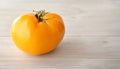 Big fresh yellow tomato on wooden background. Selective focus. Close up. Copy space for text. Concept healthy, wholesome and Royalty Free Stock Photo