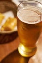 Big frozen glass with a light beer and head of foam on old dark desk. Drink and beverages concept Royalty Free Stock Photo