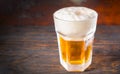 Big frozen glass with a light beer and a large head of foam on o Royalty Free Stock Photo