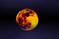 Big full colourful yellow red moon in dark navy blue sky and some small stars.