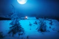 Big full moon above the winter village Royalty Free Stock Photo