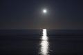 Big full moon is rising above the sea at night. Lunar light reflected on the water. Lunar path. Ocean. Royalty Free Stock Photo