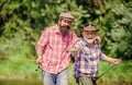 Big game fishing. friendship. hunting tourism. father and son fishing. two happy fisherman with fishing rod and net Royalty Free Stock Photo