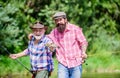 Big game fishing. friendship. hunting tourism. father and son fishing. two happy fisherman with fishing rod and net Royalty Free Stock Photo