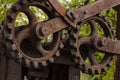 Big gear old mechanism engine group of shafts background industrial grunge street sawmill texture metal rusty close-up Royalty Free Stock Photo