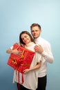 Beautiful couple in love on blue studio background. Valentine& x27;s Day, love and emotions concept Royalty Free Stock Photo