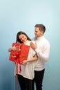 Beautiful couple in love on blue studio background. Valentine& x27;s Day, love and emotions concept Royalty Free Stock Photo