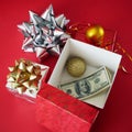 Big gift box with ribbon bow and stack of money, merry chirtmas and happy new year Royalty Free Stock Photo