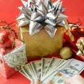 Big gift box with ribbon bow and stack of money, merry chirtmas and happy new year concept, closeup Royalty Free Stock Photo