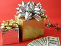 big gift box with ribbon bow and stack of money, merry chirtmas and happy new year concept Royalty Free Stock Photo