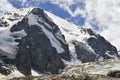 A big glacier covering the rocky mountain