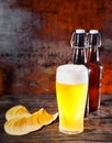 Big glass of freshly poured unfiltered light beer against two be Royalty Free Stock Photo