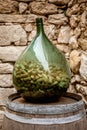 Big glass wine bottle half full of corks in the picturesque Eze Royalty Free Stock Photo