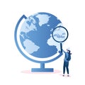 Big globe with map and female traveler looks into a magnifying glass,travel route concept,girl hipster with backpack